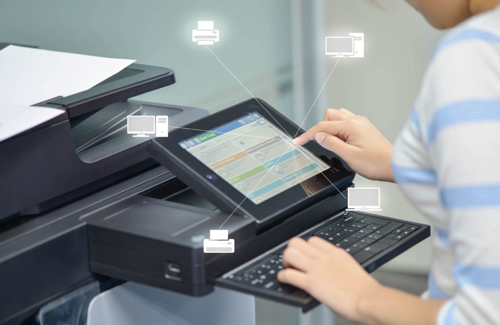 Business woman is using a printer to scan document to network folder with icon of printer and computer.